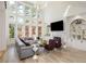 This elegant living room features a fireplace, built-in shelves, and hardwood floors with natural light at 2461 Oak Grove Ne Ests, Atlanta, GA 30345