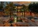 A luxurious backyard pool area with lush landscaping, a spa, and a multi-level patio at sunset at 2461 Oak Grove Ne Ests, Atlanta, GA 30345