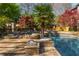 Resort-style pool with stone features, lush landscaping, and an outdoor kitchen and bar area at 2461 Oak Grove Ne Ests, Atlanta, GA 30345