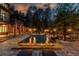 A stunning backyard pool featuring a fire feature, stone accents, and lounge chairs on a multi-level patio at 2461 Oak Grove Ne Ests, Atlanta, GA 30345