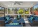 Bright sunroom with large windows, comfortable seating, and a ceiling fan at 2461 Oak Grove Ne Ests, Atlanta, GA 30345