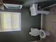 Bathroom featuring tile walls, toilet, and window; ready for updating to personal tastes at 2670 Foxlair Trl, South Fulton, GA 30349