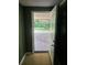 Open back door leads to the outside yard with a concrete patio and a view of the green trees at 2670 Foxlair Trl, South Fulton, GA 30349