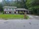 View of two-story house with a green front lawn and two-tone exterior at 2670 Foxlair Trl, South Fulton, GA 30349