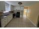 Functional kitchen features white cabinets and countertops with a stainless steel sink and black appliances at 2670 Foxlair Trl, South Fulton, GA 30349