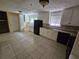 Spacious kitchen featuring granite countertops, black appliances, white cabinets, and tile floors at 2670 Foxlair Trl, South Fulton, GA 30349