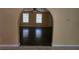 Spacious living room with hardwood floors and view to arched entryways with a ceiling fan at 2670 Foxlair Trl, South Fulton, GA 30349