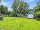 Spacious backyard with large, grassy lawn, wooden fence and storage shed at 4517 Baker Grove Nw Rd, Acworth, GA 30101