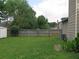 Green backyard featuring a wood fence, grass and an exterior air conditioning unit at 4517 Baker Grove Nw Rd, Acworth, GA 30101