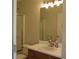 Bathroom featuring a single sink vanity, shower, and a framed mirror at 4517 Baker Grove Nw Rd, Acworth, GA 30101