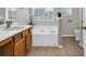Bright bathroom featuring a soaking tub, tile floors, vanity and natural light at 4517 Baker Grove Nw Rd, Acworth, GA 30101