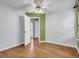 Bedroom with hardwood floors, neutral walls, and an open doorway at 4517 Baker Grove Nw Rd, Acworth, GA 30101