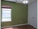 Bedroom featuring green walls, hardwood floors, and a window with blinds at 4517 Baker Grove Nw Rd, Acworth, GA 30101