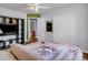 Bedroom with hardwood floor, white closet doors, and storage shelf unit with television at 4517 Baker Grove Nw Rd, Acworth, GA 30101