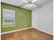 Bright bedroom featuring hardwood floors, a window, and neutral-colored walls at 4517 Baker Grove Nw Rd, Acworth, GA 30101