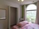 Charming bedroom with a large window, closet, and soft natural lighting at 4517 Baker Grove Nw Rd, Acworth, GA 30101