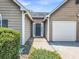 Close-up of the front entrance, highlighting the door, sidelights, and garage at 4517 Baker Grove Nw Rd, Acworth, GA 30101