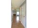 Bright hallway with hardwood floors leading to a living room with a fireplace at 4517 Baker Grove Nw Rd, Acworth, GA 30101
