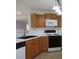 Kitchen showcasing wood cabinets, a microwave, and modern appliances at 4517 Baker Grove Nw Rd, Acworth, GA 30101