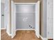 Laundry room with hardwood floors and white doors at 4517 Baker Grove Nw Rd, Acworth, GA 30101