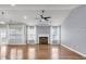 Bright living room with hardwood floors, a fireplace, and windows with sheer curtains at 4517 Baker Grove Nw Rd, Acworth, GA 30101