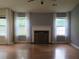 Spacious living room showcasing fireplace, large windows and hardwood flooring at 4517 Baker Grove Nw Rd, Acworth, GA 30101