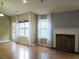 Well-lit living room with hardwood floors, a fireplace, and sheer curtains at 4517 Baker Grove Nw Rd, Acworth, GA 30101
