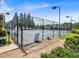 Outdoor tennis court surrounded by trees and a fence for privacy and security at 4517 Baker Grove Nw Rd, Acworth, GA 30101
