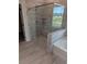 Luxurious bathroom featuring a glass-enclosed shower and tile surround at 596 Rodeo Dr, Auburn, GA 30011