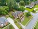 Aerial view of a red brick two-story home with mature landscaping and a long driveway at 1360 Wilmington Way, Grayson, GA 30017