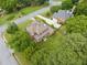 Aerial view of a two-story home with a manicured lawn and a detached two-car garage at 1360 Wilmington Way, Grayson, GA 30017