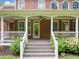 Covered back porch with ceiling fan and stairway to large landscaped backyard at 1360 Wilmington Way, Grayson, GA 30017