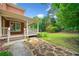 Beautifully landscaped backyard with stepping stone pathway, green lawn, and a covered porch at 1360 Wilmington Way, Grayson, GA 30017