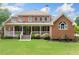 Expansive backyard with covered porch, lush green lawn, and mature landscaping, great for relaxing and entertaining at 1360 Wilmington Way, Grayson, GA 30017