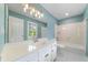 Bathroom features a long countertop with sink and a window with plantation shutters for plenty of natural light at 1360 Wilmington Way, Grayson, GA 30017