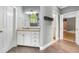 Bright bathroom with white cabinetry, granite countertops, and wood-look tile flooring at 1360 Wilmington Way, Grayson, GA 30017