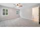 Large bedroom with new carpet, neutral walls, and views of the yard through two large windows at 1360 Wilmington Way, Grayson, GA 30017