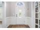 Inviting entryway with hardwood floors, decorative molding, and a beautiful front door with glass inset at 1360 Wilmington Way, Grayson, GA 30017