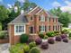 Handsome brick home featuring meticulous landscaping and a welcoming front entry at 1360 Wilmington Way, Grayson, GA 30017