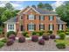 Beautiful brick home featuring a landscaped front yard with lush greenery and charming curb appeal at 1360 Wilmington Way, Grayson, GA 30017