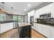 Modern kitchen featuring granite countertops, stainless steel appliances, and a center island at 1360 Wilmington Way, Grayson, GA 30017
