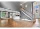 Spacious living area showcasing hardwood floors, an open staircase, and kitchen access, ideal for entertaining at 1360 Wilmington Way, Grayson, GA 30017