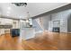 Open-concept living room and kitchen with hardwood floors, fireplace and built-in shelving at 1360 Wilmington Way, Grayson, GA 30017
