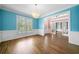 Bright living area with hardwood floors, wainscoting, and a statement chandelier for elegant charm at 1360 Wilmington Way, Grayson, GA 30017