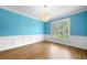 Living area featuring hardwood floors, wainscoting, natural light, and a decorative light fixture at 1360 Wilmington Way, Grayson, GA 30017
