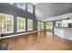 Sun-drenched living room with high ceilings, large windows, and an open layout to the kitchen at 1360 Wilmington Way, Grayson, GA 30017