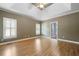 Spacious primary bedroom with tray ceilings, hardwood floors, and ample natural light at 1360 Wilmington Way, Grayson, GA 30017