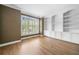 Well-lit office with hardwood floors, built-in shelving, and large windows with bright natural light at 1360 Wilmington Way, Grayson, GA 30017