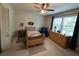Carpeted bedroom features ceiling fan, natural light, and wood furnishings at 1610 Sprayberry Dr, Marietta, GA 30066
