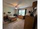Carpeted bedroom featuring ceiling fan, natural light, and wood furnishings at 1610 Sprayberry Dr, Marietta, GA 30066